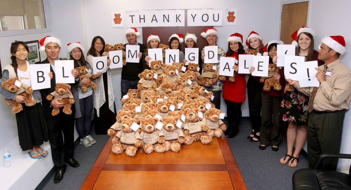 Glendale Adventist Medical Center employeea and volunteers alogn with Bloomingdale's public relations manager Kelli Daley helped pass out teddy bears to patients for the holidays, at GAMC in Glendale on Wednesday, December 23, 2015. Sixty stuffed bears were handed out to patients throughout the hospital. A donor gave 30 bears and Bloomingdale's match the gift with another 30 bears.