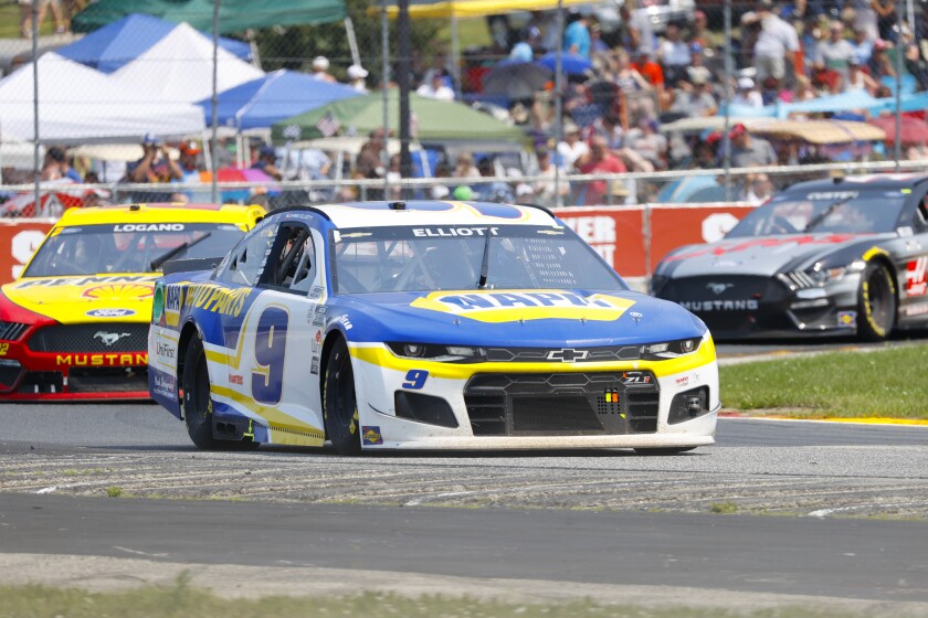 Chase Elliott (9) leads a group through a turn during a NASCAR Cup Series.