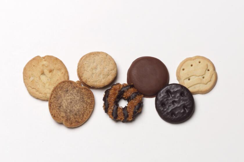 Girl Scout Cookies left to right: Aloha Chip, Apple Cinnamon, Do-Si-Do, Samoa, Tagalong, Thin Mint and Trefoil.