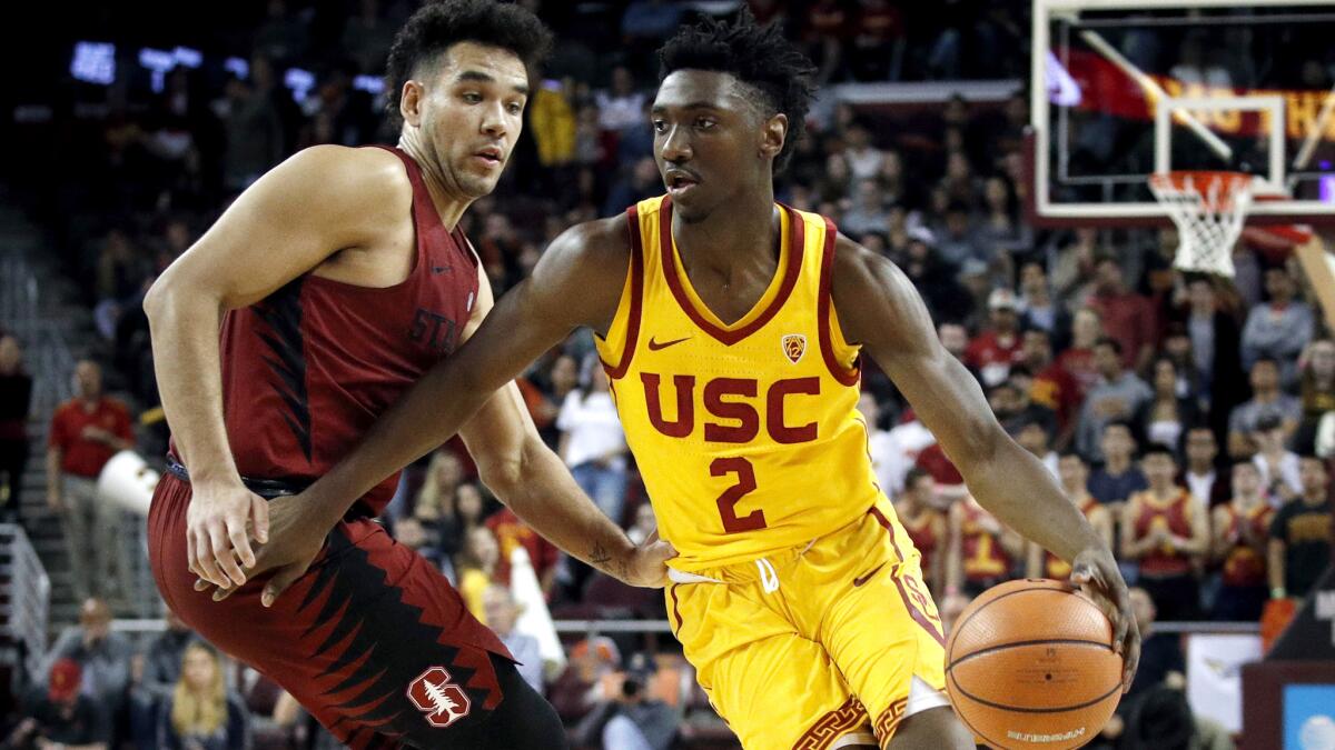 USC guard Jonah Mathews drives past Stanford's Dorian Pickens during the second half of their game Wednesday.