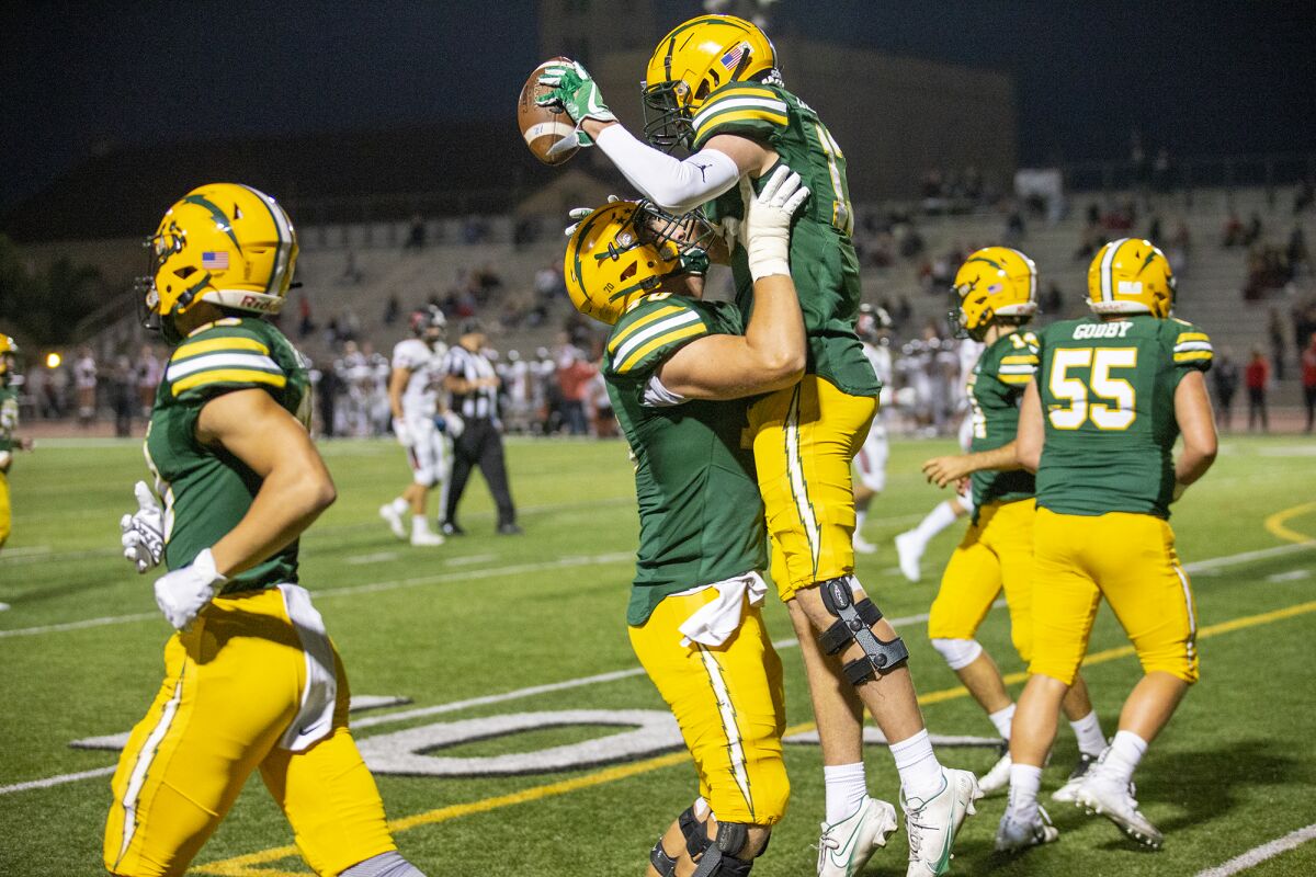 Edison's Nathan Gates lifts Tyler Hampton in celebration after Hampton scored in the first half against San Clemente.