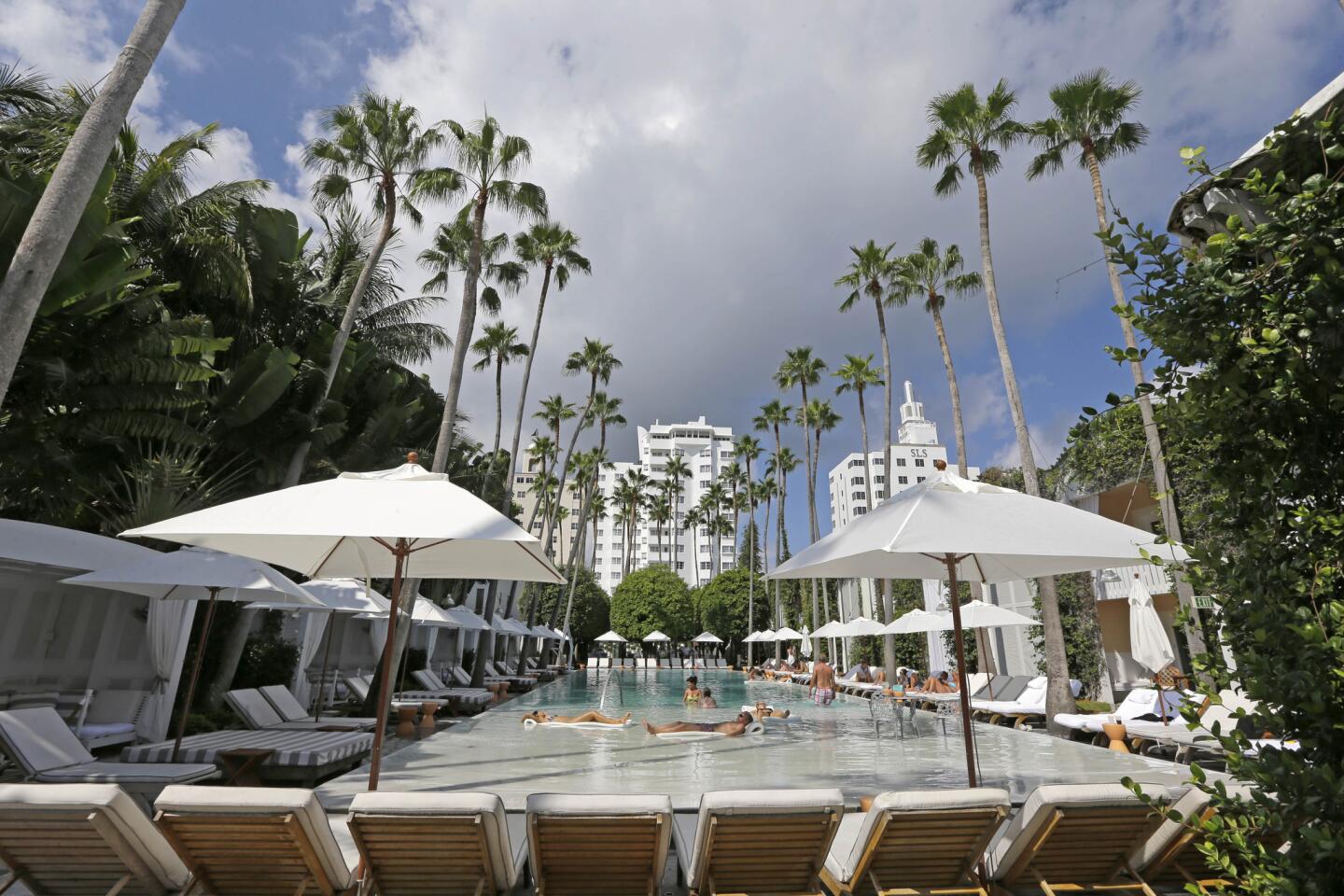 This photo taken Friday, Oct. 9, 2015, shows the pool of the Hotel Delano South Beach in Miami Beach, Fla. The design ideals and social experience offered at the Delano have almost become industry standards, as major hotel chains have launched new “boutique” brands aimed at millennials and design-savvy travelers. (AP Photo/Alan Diaz) ORG XMIT: FLAD214