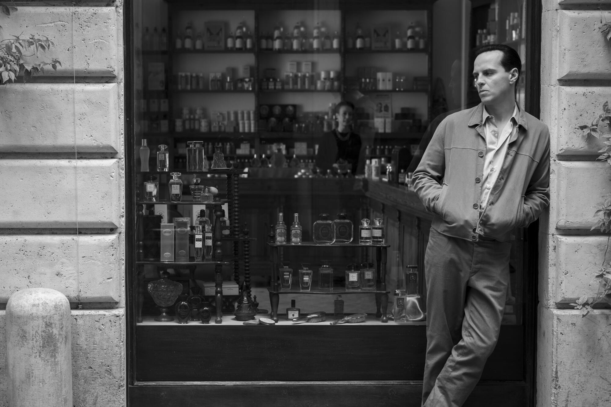 A man leans against the stone wall of a storefront in "Ripley."