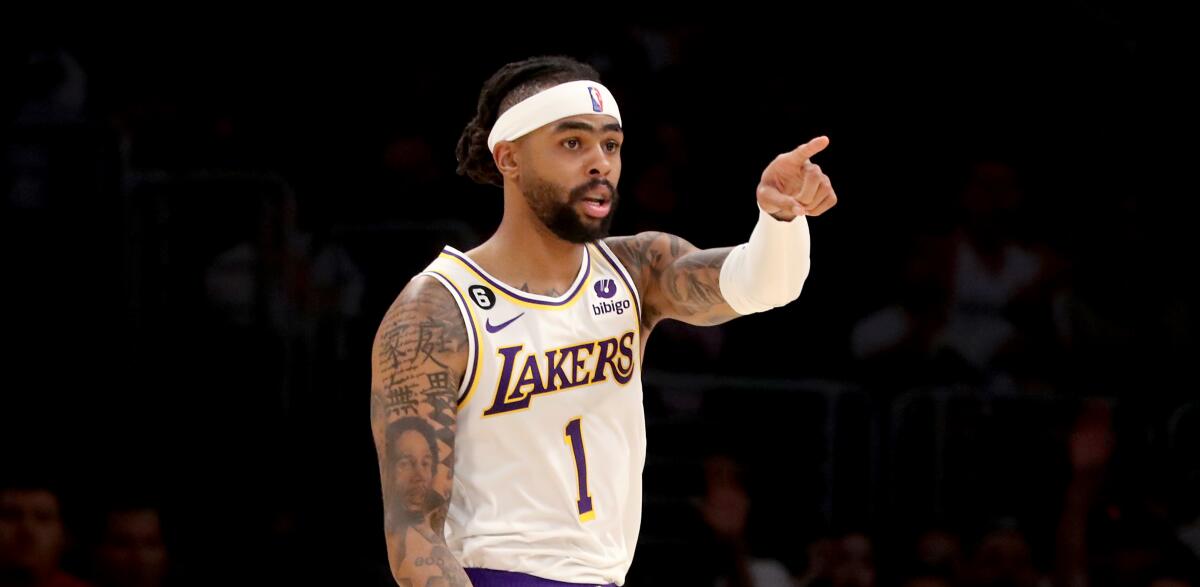 Lakers point guard D'Angelo Russell points to a teammate, who assisted on his three-point shot.
