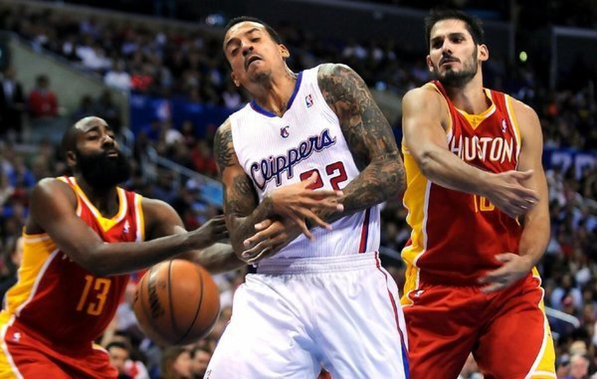 The Clippers' Matt Barnes has the ball stripped away from him by the Rockets' James Harden.