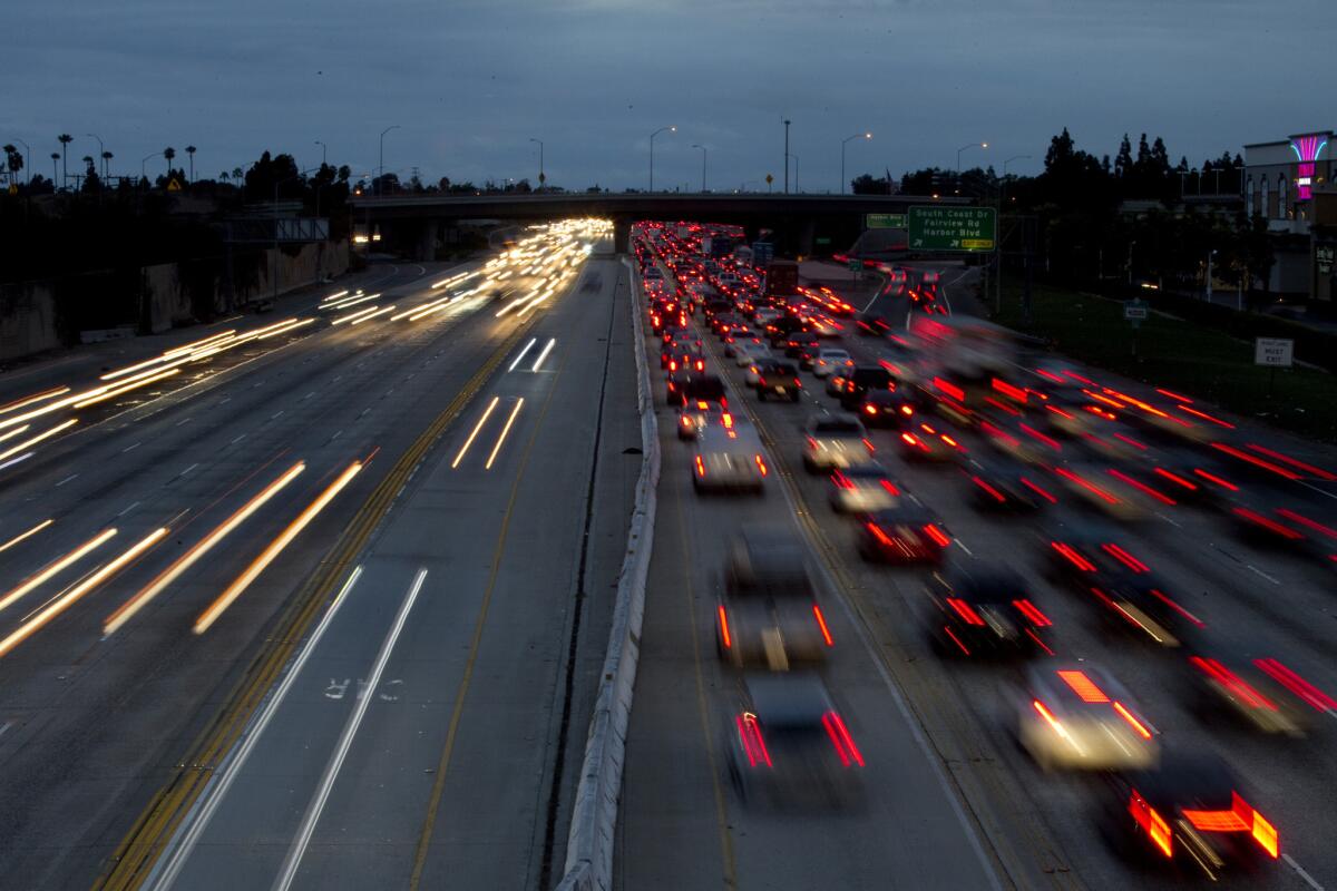 A long camera exposure reveals the blurred lights of motorists traveling on the 405 Freeway through Costa Mesa in 2013. A bill by two O.C. Assembly members would ban the addition of toll lanes to the 405 Freeway, or other freeways, unless voters approve.
