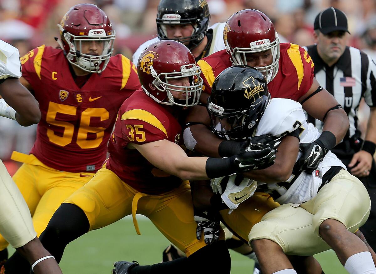USC linebacker Cameron Smith brings down Idaho running back Elijah Penny in the second quarter on Saturday at the Coliseum.