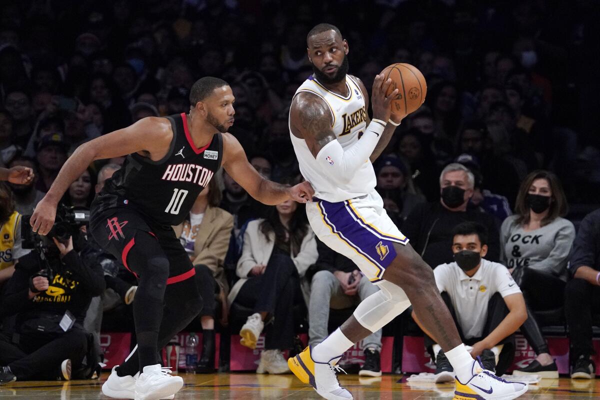 Lakers forward LeBron James tries to move past Houston Rockets guard Eric Gordon.