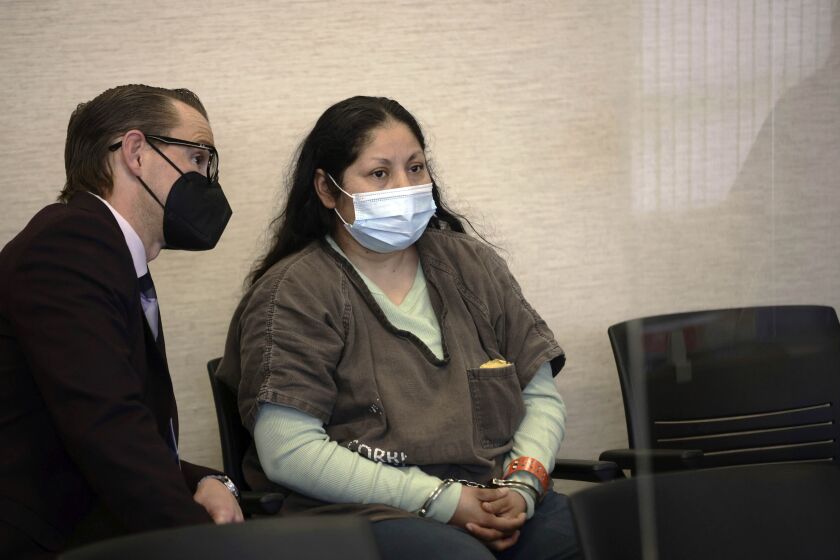FILE - Yesenia Guadalupe Ramirez, center, one of two suspects charged in connection with the kidnapping of a 3-month-old baby in San Jose, appears with attorney Cody Salfen for her arraignment hearing at the Santa Clara County Hall of Justice on Thursday, April 28, 2022, in San Jose, Calif. Ramirez was sentenced Monday, March 20, 2023, to 13 years and four months in prison. Jose Portillo received five years. They earlier pleaded no contest to kidnapping Brandon Cuellar from his San Jose apartment in April 2022. (Dai Sugano/Bay Area News Group via AP, Pool, File)