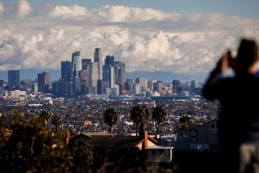LOS ANGELES,CA --SATURDAY, DECEMBER 24, 2016--After dropping a friend at LAX airport, Mike Che, from West Hollywood, stopped at Kenneth Hahn Recreation Area to take in the skyline of downtown Los Angeles, CA, following a winter storm, Christmas Eve morning, Dec. 24, 2016. (Jay L. Clendenin / Los Angeles Times)