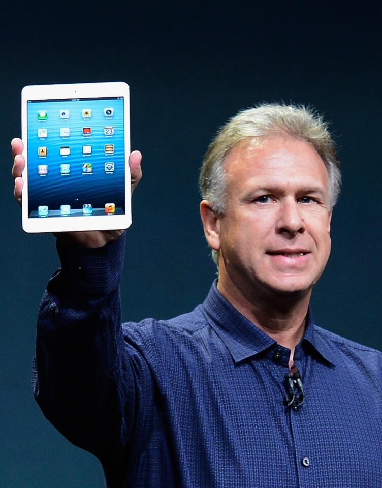 Apple Inc. marketing chief Phil Schiller displays the new iPad Mini to reporters as the new device in unveiled in San Jose