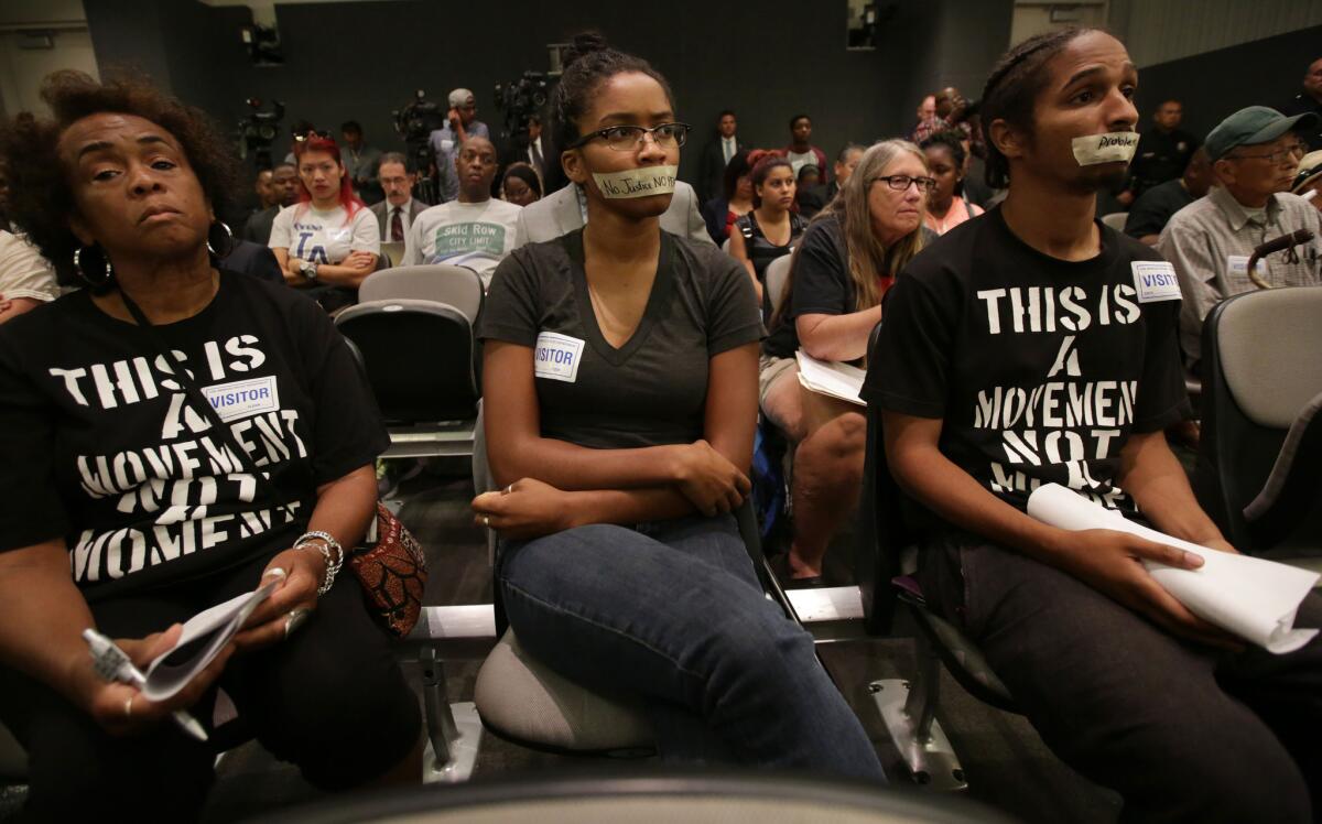 Attendees participate in a silent protest at the weekly Los Angeles Board of Police Commissioners meeting on Sept. 30.