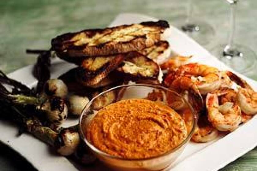 Recipe: Romesco with grilled bread, spring onions and shrimp.