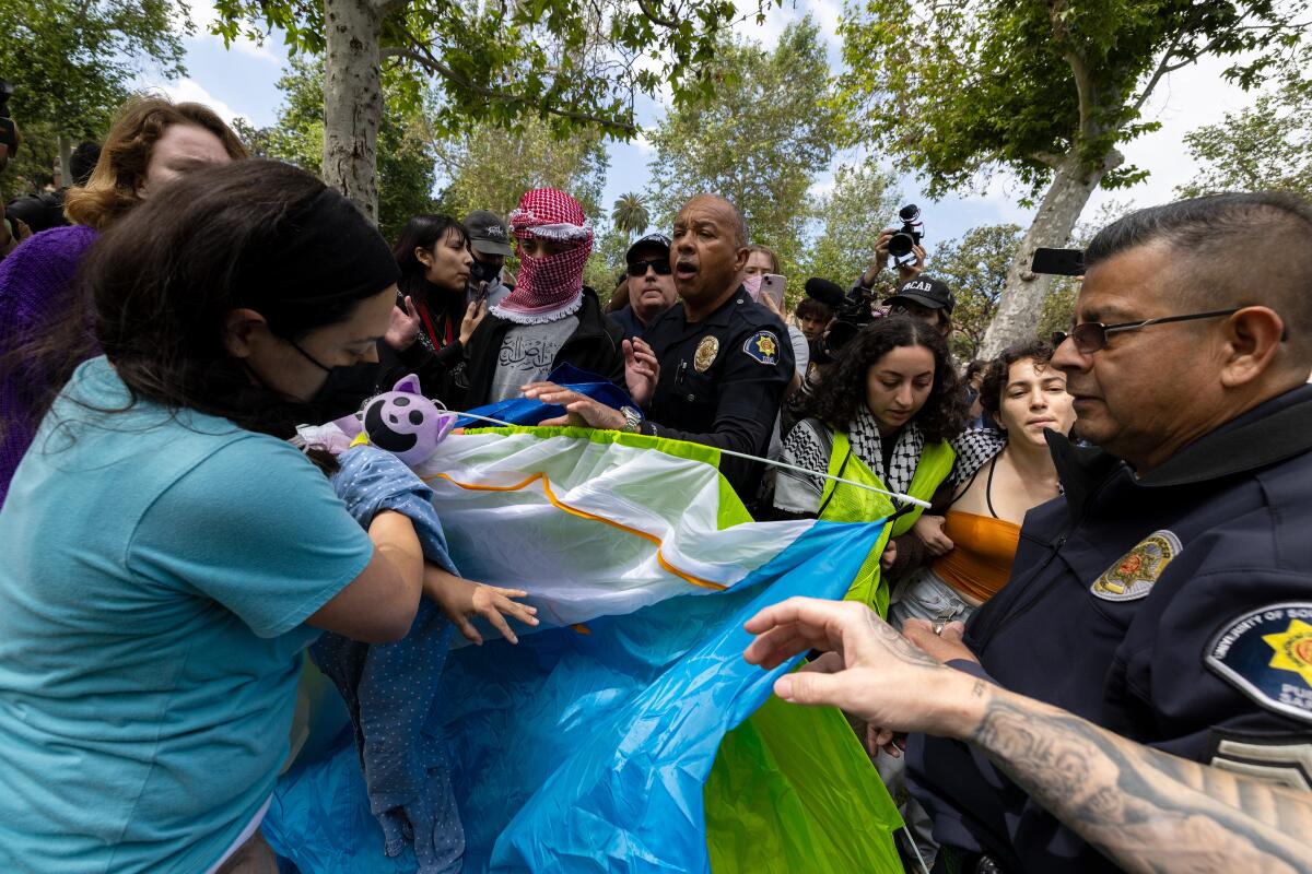 Campus safety officers try to confiscate tents from pro-Palestinian demonstrators at USC on April 24. 