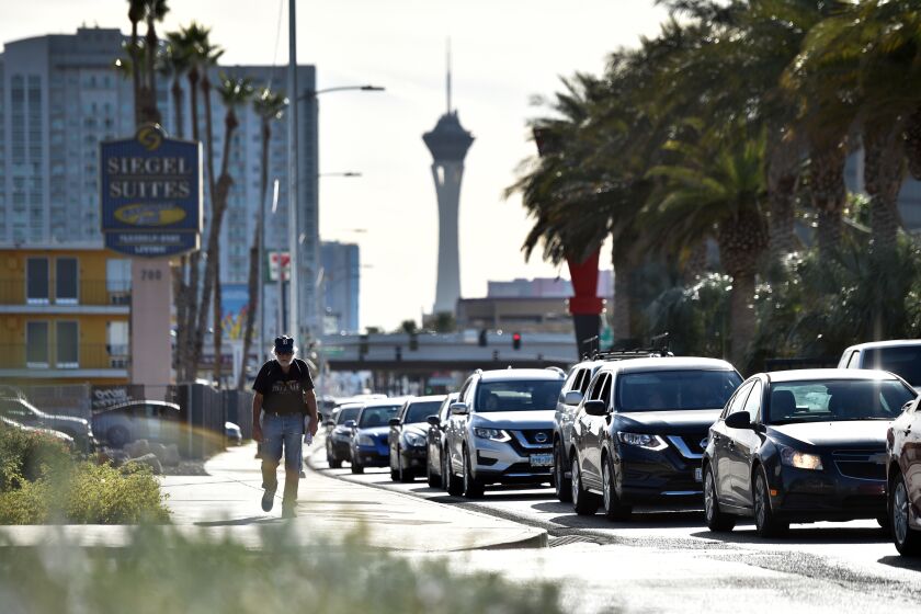 Vehicle traffic backs up along Las Vegas Boulevard as they wait to enter the Fall Giving Pop-Up, a one-day event providing free food assistance to Clark County residents adversely impacted by the coronavirus pandemic on Saturday, Nov. 21, 2020, in Las Vegas. (Photo by David Becker/For the Times)