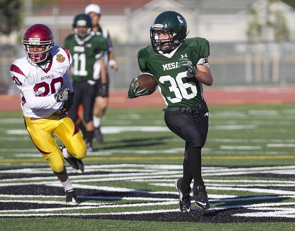 Costa Mesa High's Tyler Corkhill runs to the outside for a big gain against Estancia during the frosh-soph Battle for the Bell on Thursday.