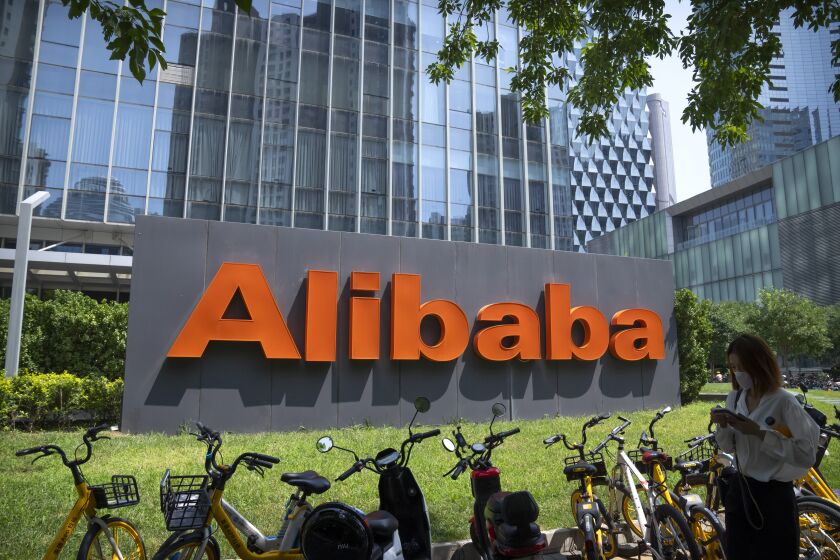 FILE - The logo of Chinese technology firm Alibaba is seen at its office in Beijing, Tuesday, Aug. 10, 2021. Alibaba is separating the company into six business groups as it looks to react faster to market changes and increase their value. Alibaba Group Holding Ltd. said, Tuesday, March 28, 2023, in a regulatory filing that it will be split into the Cloud Intelligence Group, Taobao Tmall Business Group, Local Services Group, Global Digital Business Group, Cainiao Smart Logistics and Digital Media and Entertainment Group. (AP Photo/Mark Schiefelbein, File)