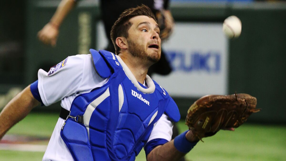 Dodgers catcher Drew Butera makes a catch during an exhibition game featuring MLB players in Tokyo on Nov. 16.