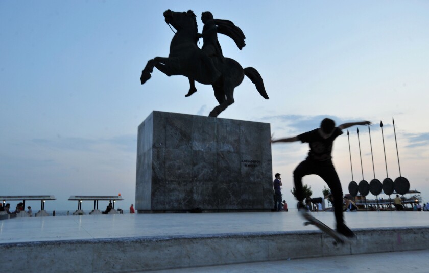 A skate boarder performes in front of a statue of Alexander the Great and his horse Bucephalus, in cental Thessaloniki, northern Greece, in May of 2009.