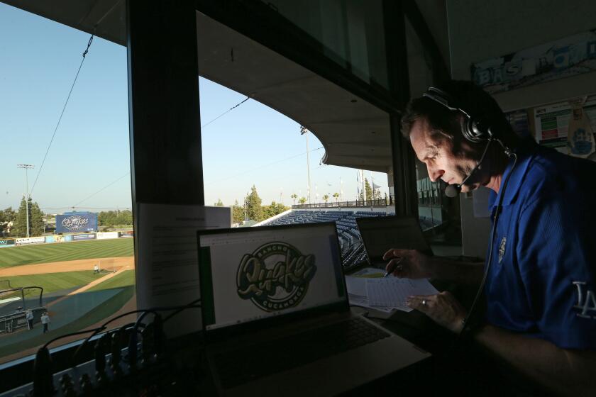 132388Rancho Cucamonga, CA - Mike Lindskog, the "Voice of the Rancho Cucamonga Quakes," a Single-A farm team affiliated with the Los Angeles Dodgers, fills out scorecards in his broadcast booth before a game at LoanMart Stadium on Thursday, Sept. 14, 2023. (Luis Sinco / Los Angeles Times)