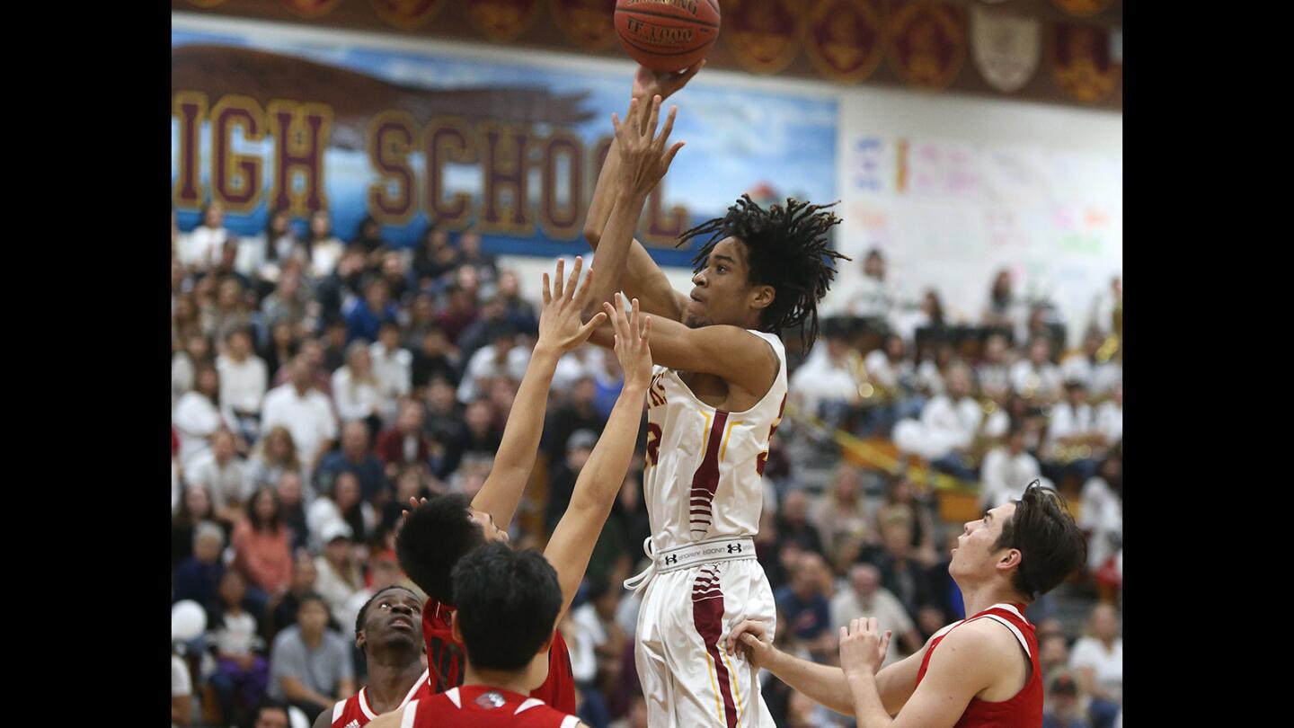 Ocean View Mehkel Harvey turns and shoots a mid-range jumper in the first half in boys varsity basketball action against Westminster on Friday.