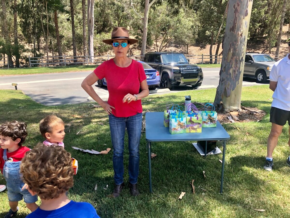 Jennifer Bonasia giving a talk to the walkers at the Fairbanks Equestrian Center, and handing out goodies for the children.