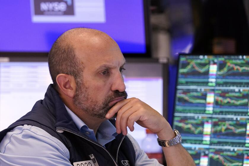 Specialist James Denaro works at his post on the floor of the New York Stock Exchange, Friday, Aug. 2, 2024. (AP Photo/Richard Drew)