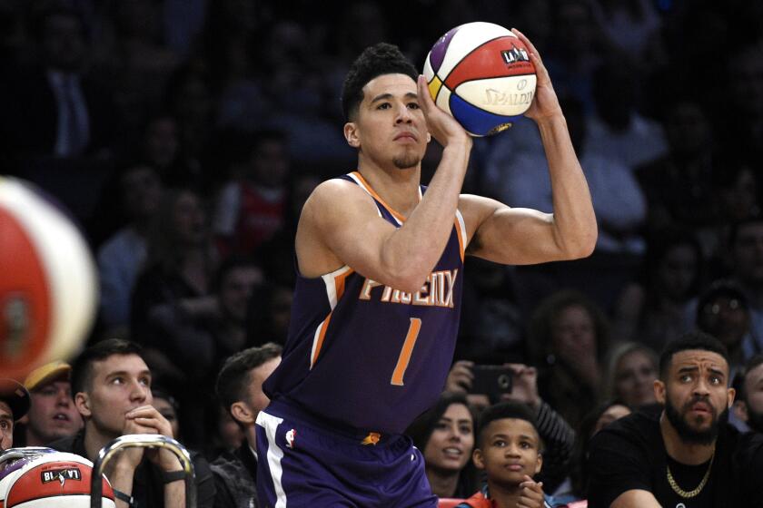 Suns guard' Devin Booker lines up a shot during the Three-Point Shooting Contest on Saturday night at Staples Center.