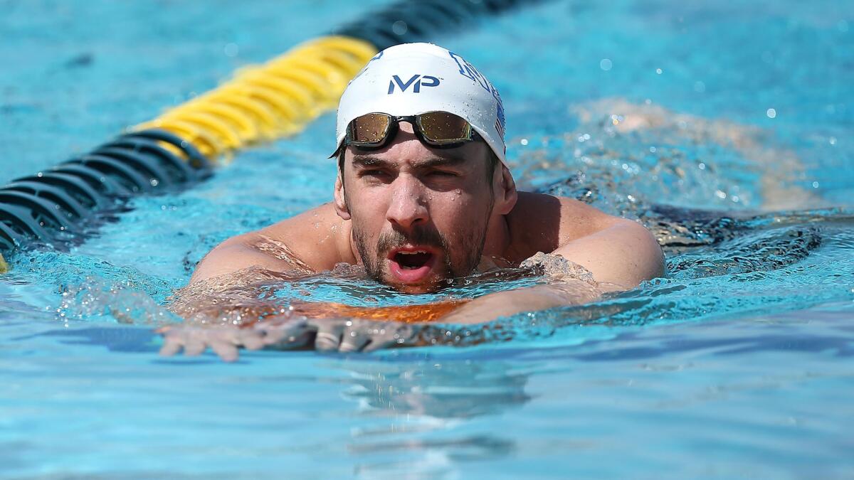 Michael Phelps warms up before taking part in the Arena Pro Swim Series in Mesa, Ariz., on Wednesday.