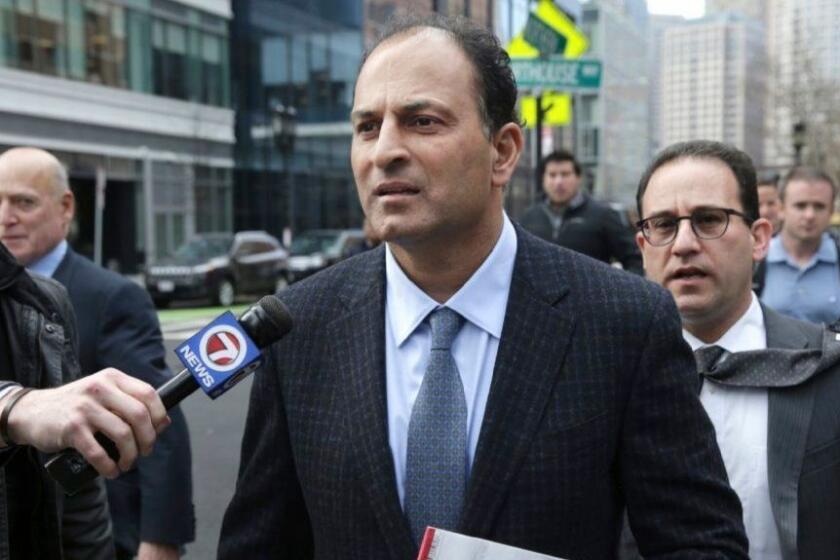 David Sidoo, of Vancouver, Canada, leaves following his federal court hearing Friday, March 15, 2019, in Boston. Sidoo pleaded not guilty to charges as part of a wide-ranging college admissions bribery scandal. (Jonathan Wiggs/The Boston Globe via AP)