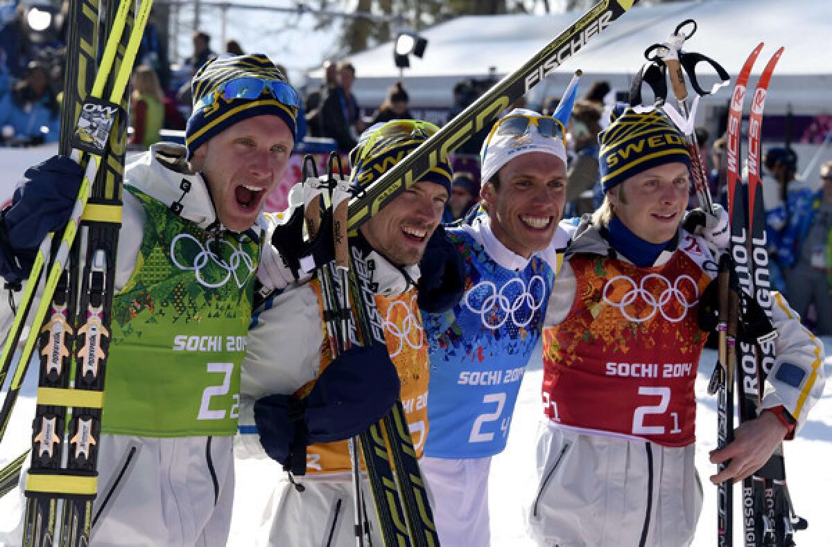 Members of the Sweden team -- from left, Daniel Richardsson, Johan Olsson, Marcus Hellner and Lars Nelson -- pose for pictures after winning the gold medal in the men's cross-country skiing 10-kilometer relay on Sunday at the Laura Cross-Country Ski and Biathlon Center during the Sochi Olympics.