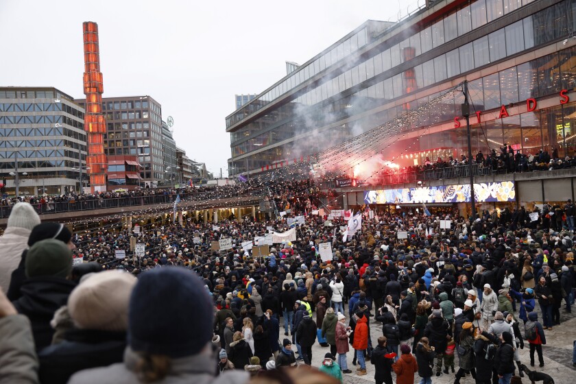 Protestors gather to demonstrate against the coronavirus measures including the vaccine pass, in Stockholm, Sweden, Saturday, Jan. 22, 2022. (Fredrik Persson/TT News Agency via AP)