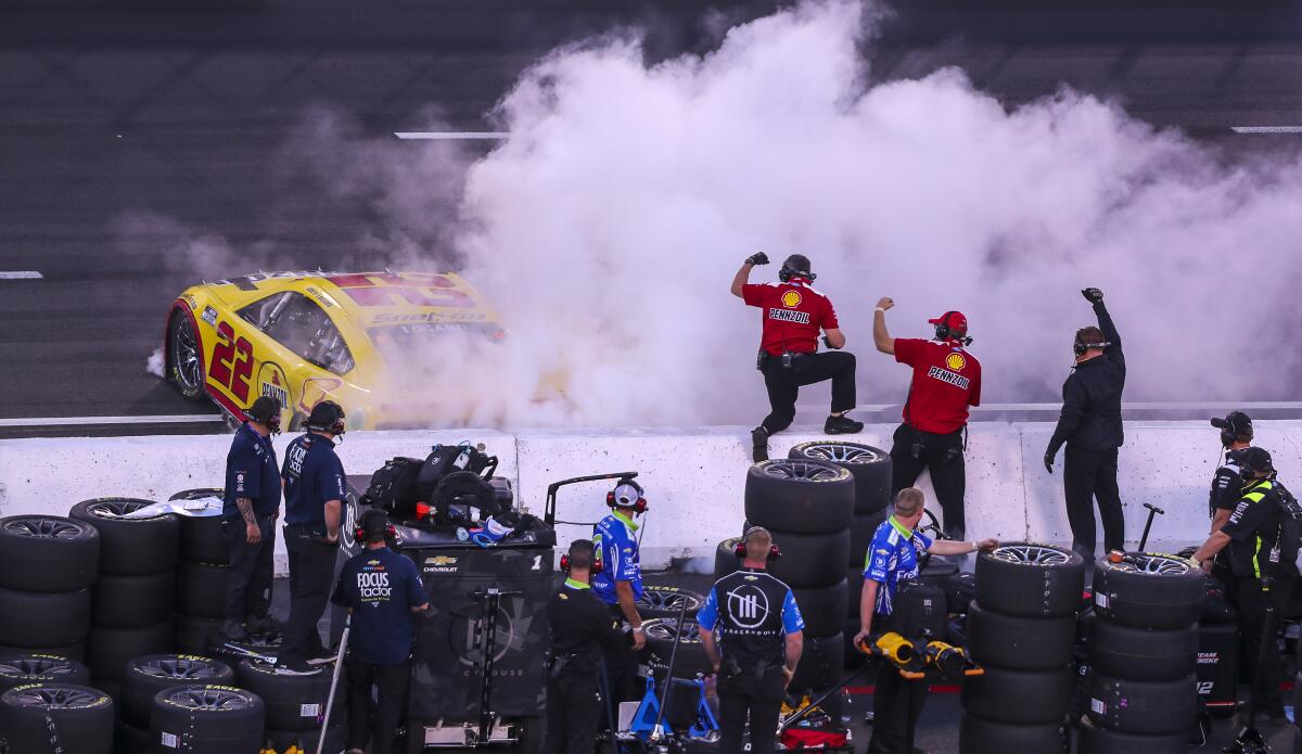Joey Logano does a celebratory burnout at the start/finish line after winning the Busch Light Clash at the Coliseum.