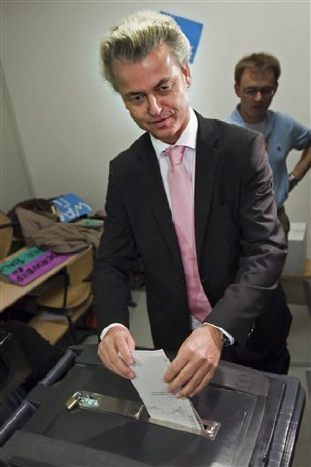 Populist anti-Islam leader Geert Wilders, center, casts his ballot in general elections in The Hague, Netherlands, Wednesday June 9, 2010. Polls opened Wednesday in the Netherlands where Dutch voters will elect a new parliament after an election campaign focused on economic and immigration policy. The conservative VVD party and its leader Mark Rutte are leading in opinion surveys on a deficit-busting, tough-on-immigration platform. The anti-Islam Freedom Party and its leader Geert Wilders also hope to book large gains. (AP Photo/Cynthia Boll)
