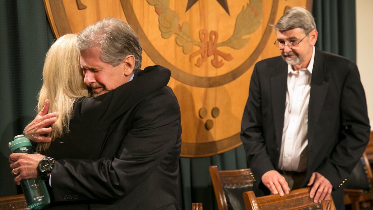 Kent Whitaker embraces his wife, Tanya, after learning the Texas Board of Pardons and Paroles voted unanimously to recommend clemency for death row inmate Thomas "Bart" Whitaker, Kent's son. Keith Whitaker, Kent's brother, looks on.