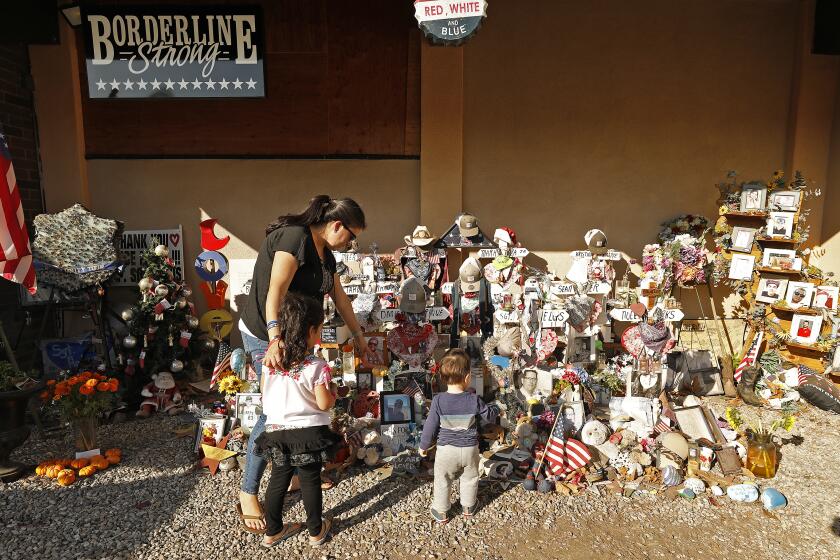 THOUSAND OAKS, CA - NOVEMBER 5, 2019 Gladys Koscak, sister of Dan Manrique, 33, who was among those killed in the mass shooting at the Borderline Bar & Grill in Thousand Oaks with her two children Sophia, 4, and Mateo, 16 months as she visits with her Mother the memorial to the 12 victims that stands in front of the country-western bar frequented by college students as the one year anniversary of the shooting on Nov 7, 2018 draws near. (Al Seib / Los Angeles Times)
