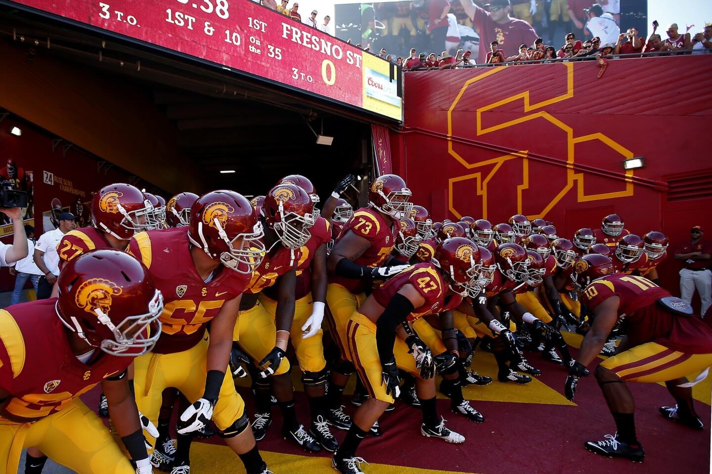 USC players get ready to take the field at the Coliseum before their season-opening game against Fresno State.