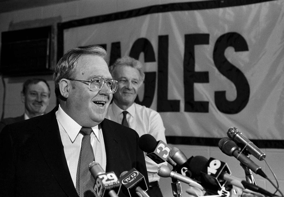 Eagles Coach Buddy Ryan talks with the media after making Ohio State's Keith Byars their number one draft pick on Apr. 29, 1986. Eagles owner Norman Braman stands in the background.