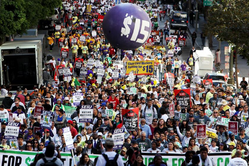 Workers march through the financial district of Los Angeles last November to press demands for a minimum wage of $15 per hour.