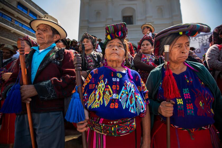 Chajul, Guatemala - May 10: Indigenous Ixil people peacefully gather on the steps infant of the Catholic Church on Wednesday, May 10, 2023, in Chajul, Guatemala. Human rights and victims groups organized a bus caravan between the three Ixil municipalities to mark the 10th anniversary of the Rios Montt sentencing for genocide. At each stop several hundred people gathered in the town's main square to read statements in Ixil and Spanish. (Francine Orr / Los Angeles Times)