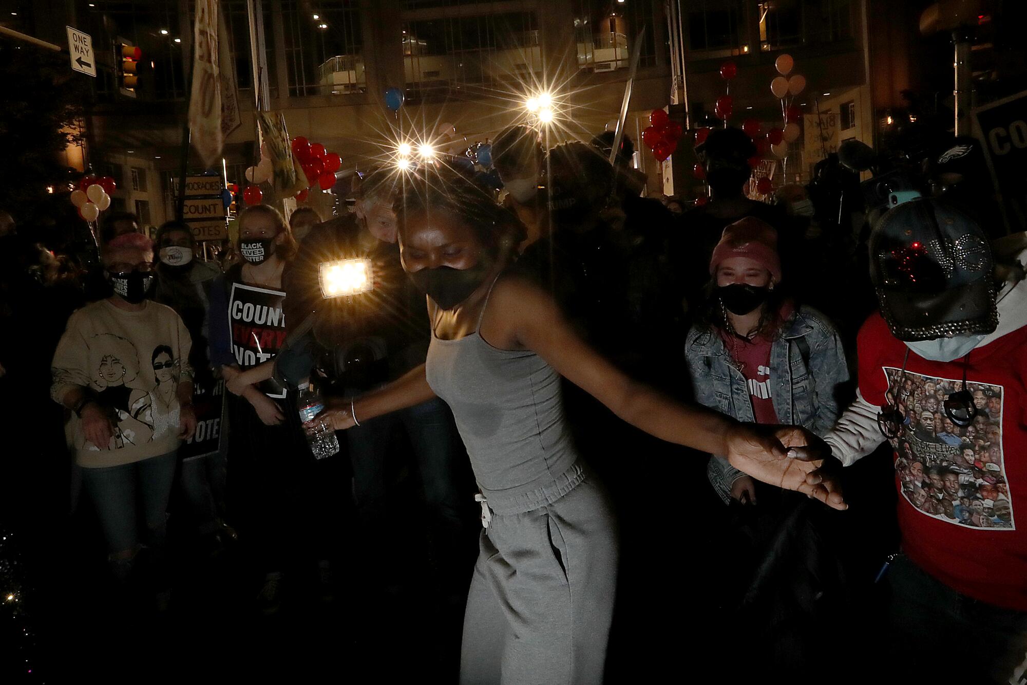 Protesters dance in the dark