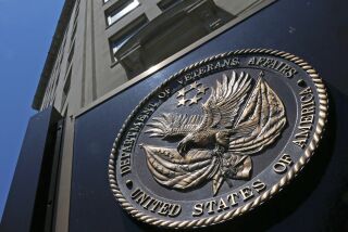 FILE - This June 21, 2013, file photo, shows the seal affixed to the front of the Department of Veterans Affairs building in Washington. In a federal lawsuit filed this week, U.S. Navy veteran from South Carolina says he ended up with “full-blown AIDS,” because government health care workers never informed him of his positive test result in 1995. He says the test was done as part of standard lab tests at a U.S. Department of Veterans Affairs medical center in Columbia, South Carolina. A V.A. spokeswoman says the agency typically does not comment on pending litigation. (AP Photo/Charles Dharapak, File)