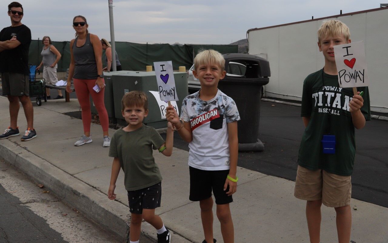 Boys with Poway signs are seen along the parade route on Sept. 10.