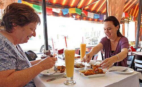 Suzy Evans of Van Nuys, left, and her friend Marguerite Kusuhara of Redondo Beach try the lunchtime fare at Tara's Himalayan Cuisine in Woodland Hills.