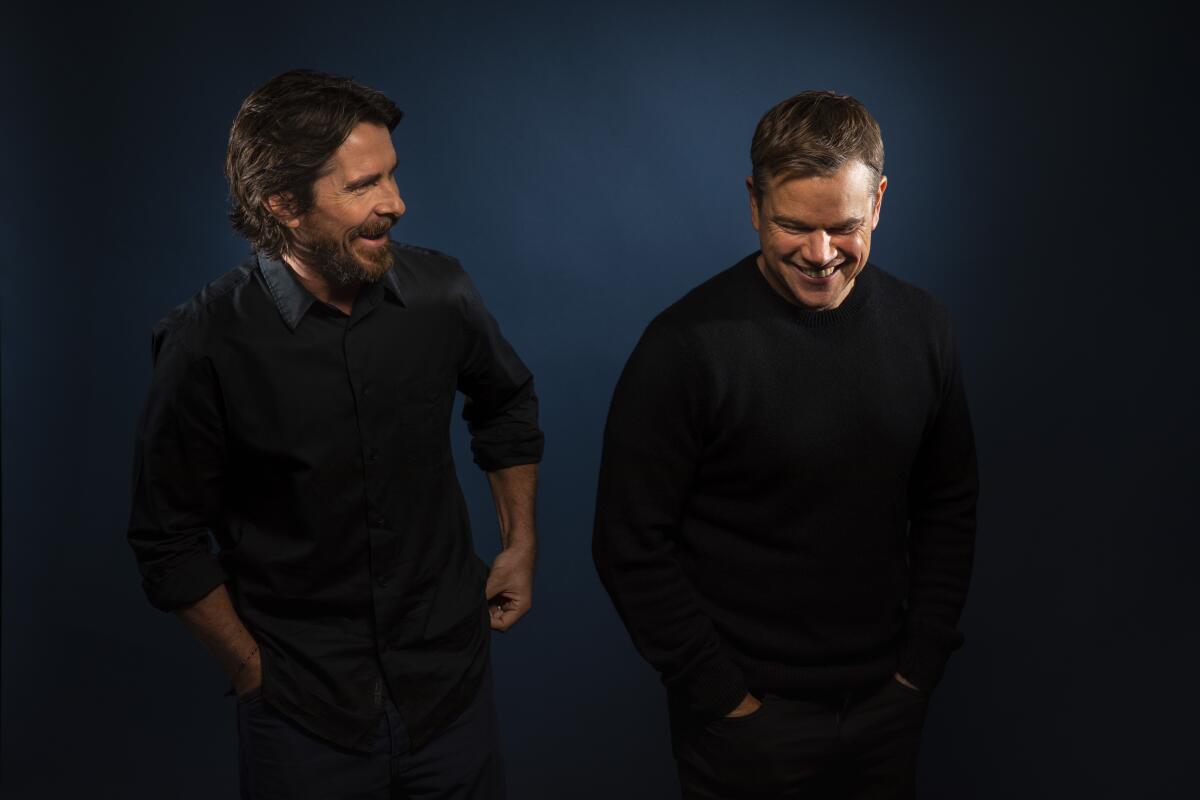 Christian Bale, left, and Matt Damon share a moment of levity.