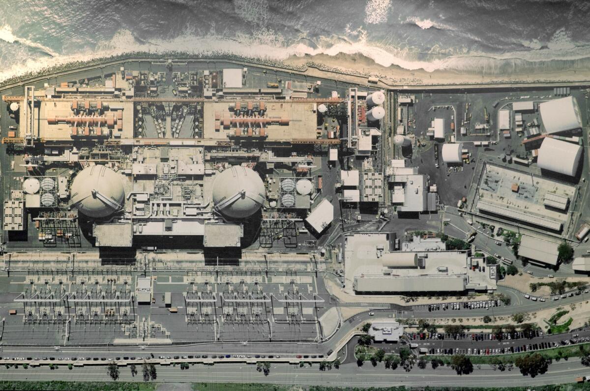 An aerial view of the closed San Onofre Nuclear Generating Station hangs on the wall of a conference room at the facility. (Allen J. Schaben / Los Angeles Times)