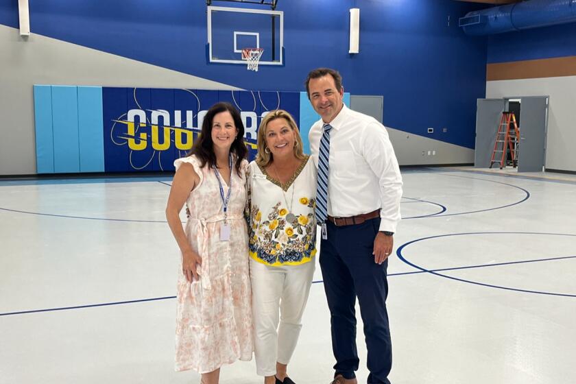 Trustee Katrina Young in the new Dieguneo Middle School Cougar Hall Principal Celeste Barnette and Associate Superintendent Bryan Marcus.