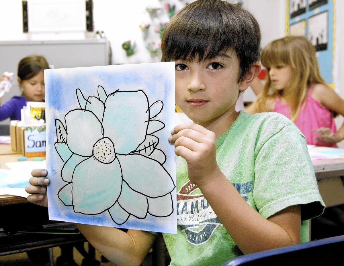 First grader Samuel Shorthouse used chalk pastels to create a flower inspired by artist Georgia O'Keeffe during art class at Stevenson Elementary School in Burbank on Thursday, May 1, 2014. The school was named a distinguished school.