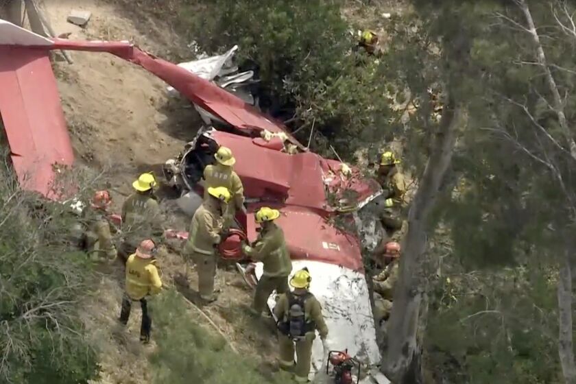 First responders t the scene where an aircraft crashed near the Foothill (210) Freeway at Hubbard Street in Sylmar. There is one confirmed fatality in the crash.