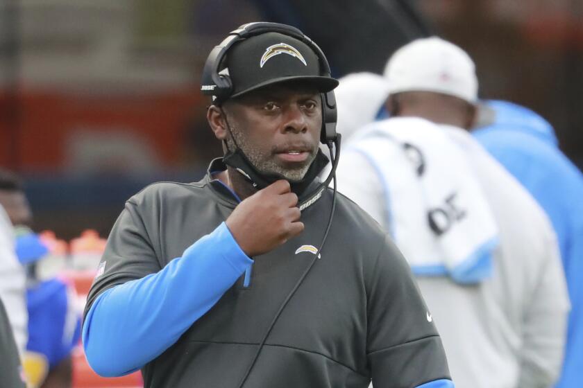 Los Angeles Chargers head coach Anthony Lynn calls in a play during an NFL football game.